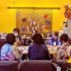 夏祭り風の飾りが施されたワンぽてぃと店内で、浴衣や甚平を着た主催者と若者たちがテーブルを囲む第3回HANASOU-ZEの様子。