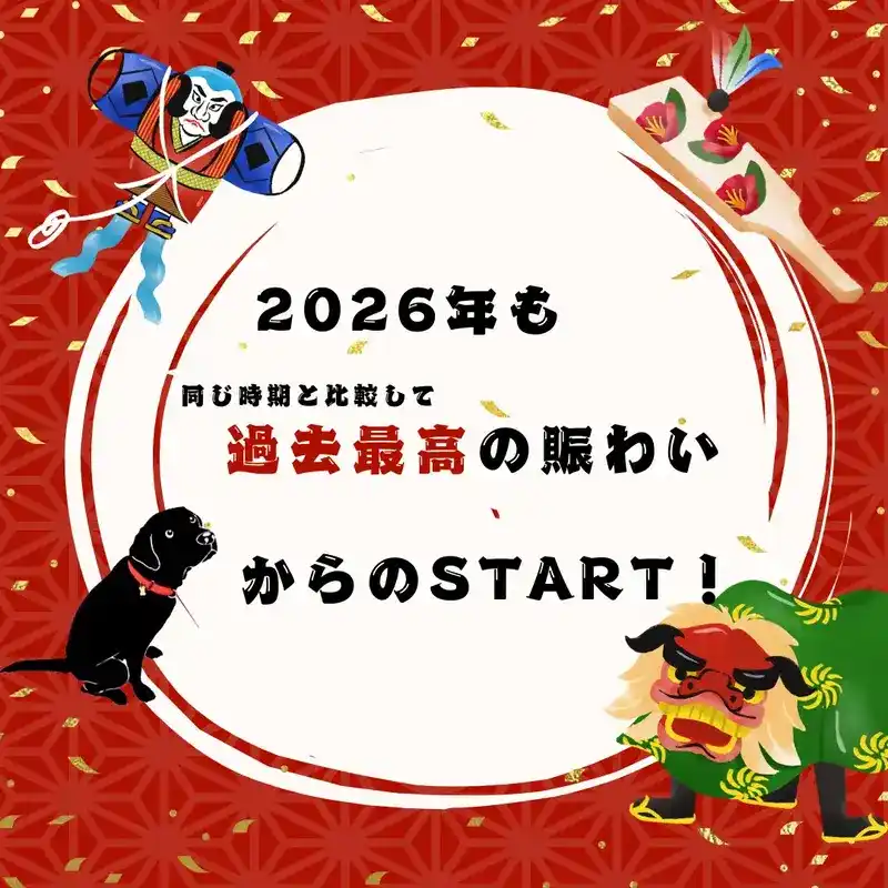 2026年の幕開けを祝う赤い和柄の背景画像。「2026年も同じ時期と比較して過去最高の賑わいからのSTART！」というテキストを中心に、凧（たこ）、羽子板、獅子舞、そして黒い犬（看板犬）のイラストが描かれている。